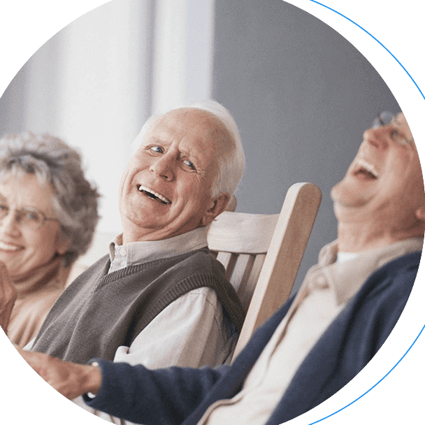 Three senior citizens laughing in chairs.